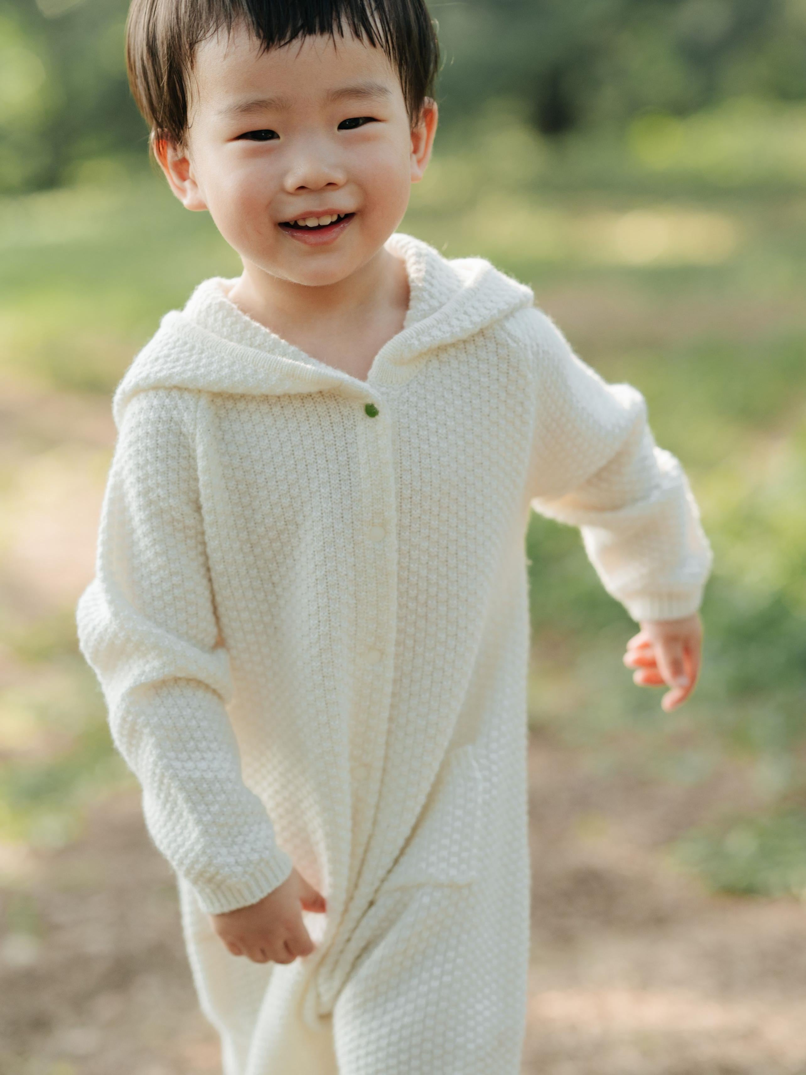 ArborTree 100% cashmere hooded onesie for kids, soft and cozy with a hood, made from naturally sourced cashmere fabric.