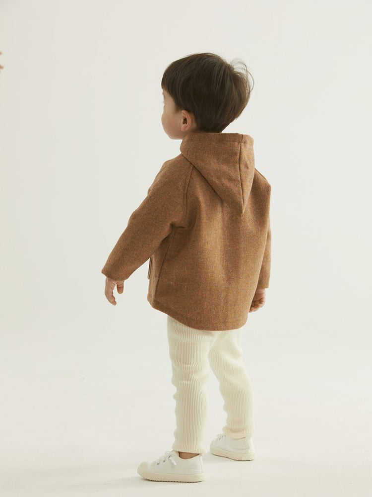 Baby wearing ArborTree soft wool coat with elf hat, featuring organic cotton lining for fall and winter warmth.