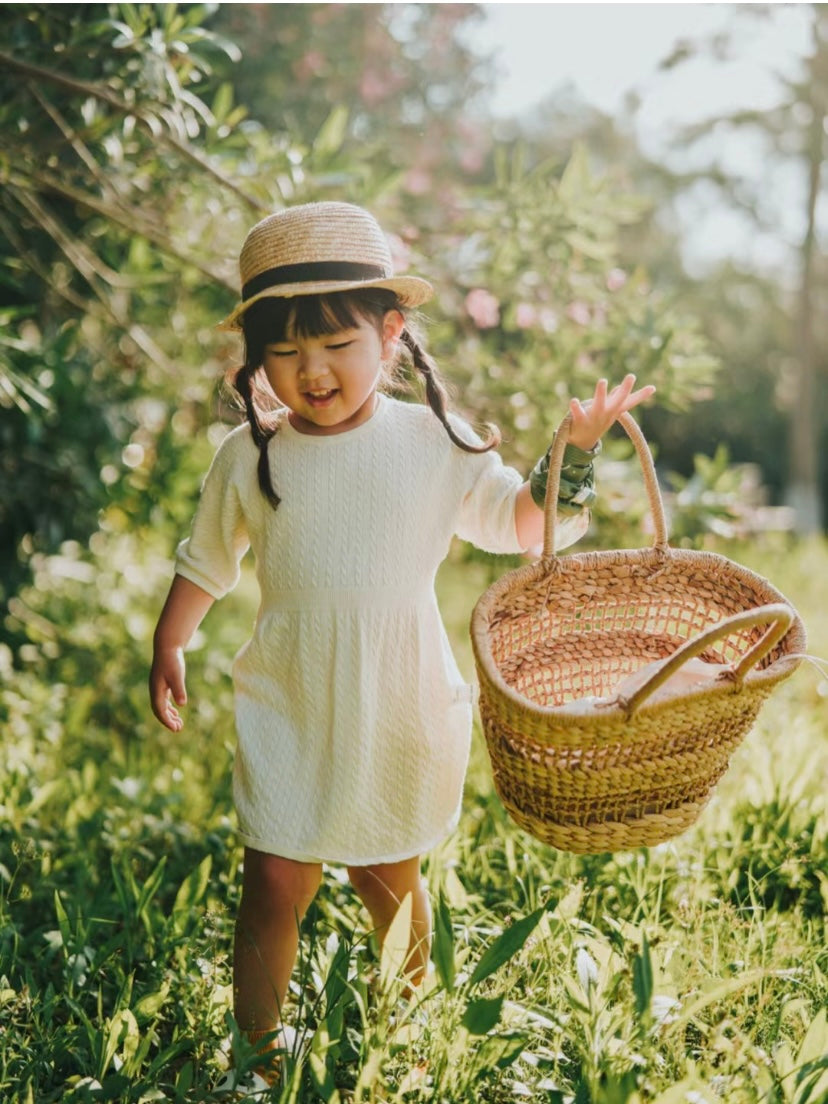 Baby wearing a soft ArborTree 100% Merino superfine wool dress, cozy and natural for infants.