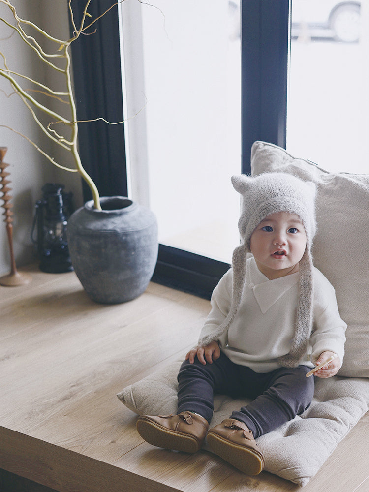 Baby pullover sweater by ArborTree made from 100% Baselwool, featuring a button-down design and soft, natural wool texture.