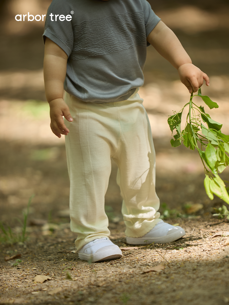 Soft beige knitted baby trousers made from 100% Mulberry silk by ArborTree, featuring a cozy, gentle design for infants.