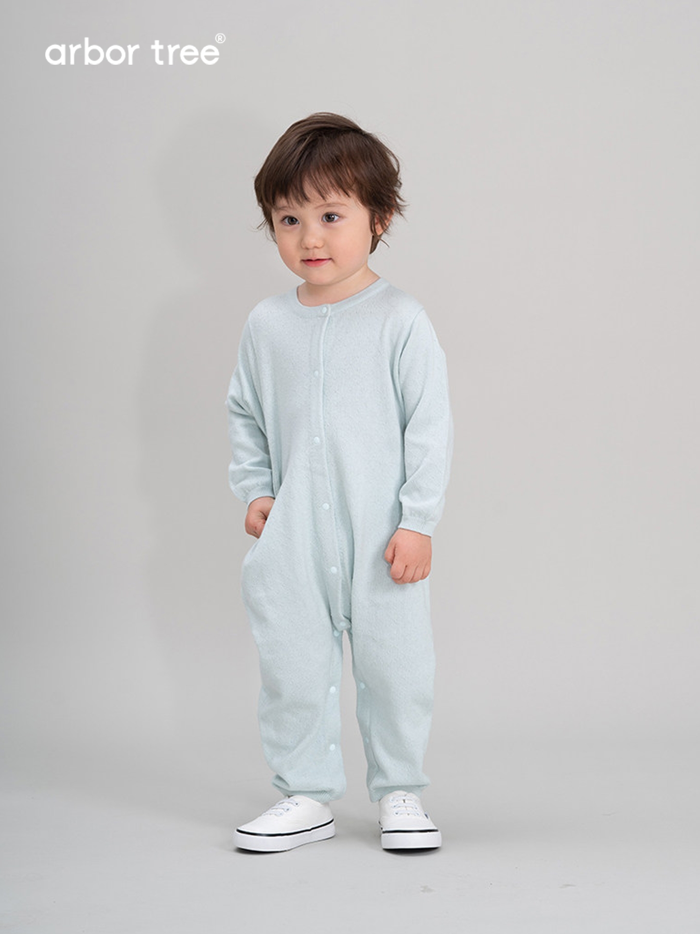 Organic cotton and cashmere baby romper by arbortree, front-opening knit lightweight toddler one-piece in soft pastel color.