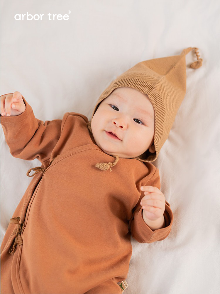 ArborTree natural organic cotton baby tie-up harness with adjustable straps and soft padding for comfortable infant safety.