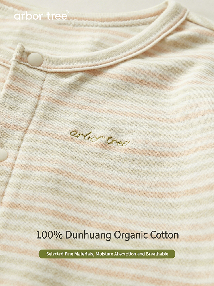 Colorful organic cotton baby bodysuit by ArborTree, featuring soft, natural fabric and vibrant patterns for infants.
