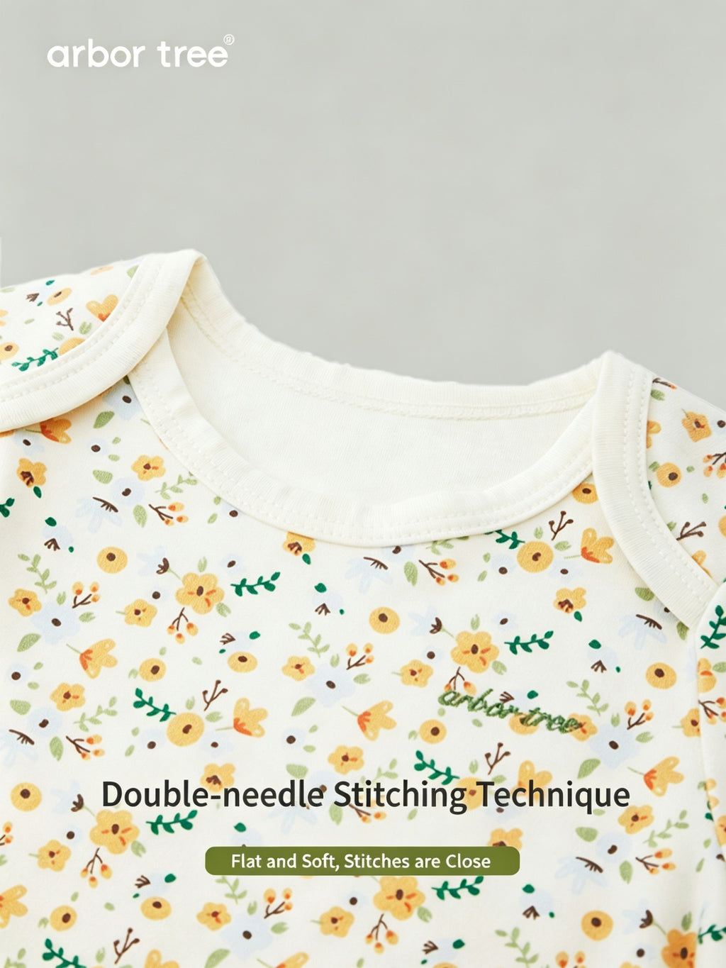 ArborTree organic cotton baby romper with small floral print, long sleeves, gentle on skin, ideal for warm weather.