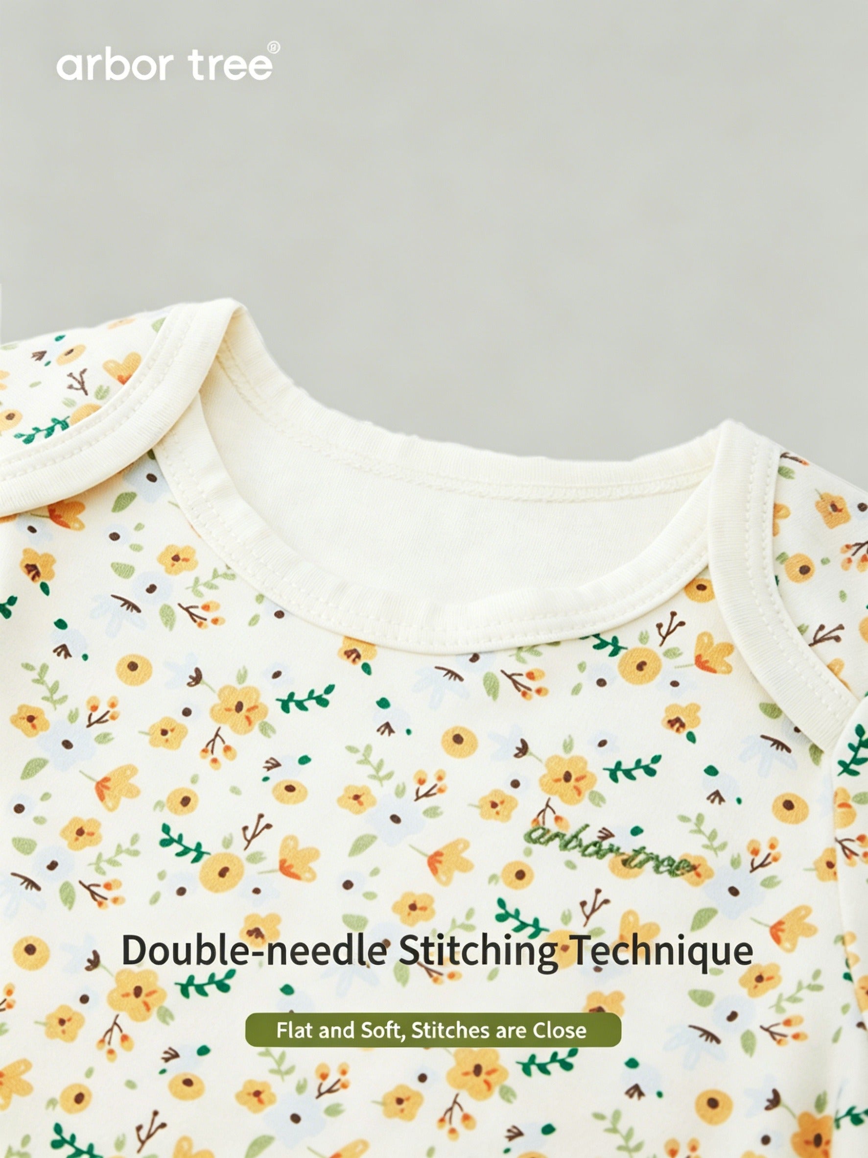 ArborTree organic cotton baby romper with small floral print, long sleeves, gentle on skin, ideal for warm weather.
