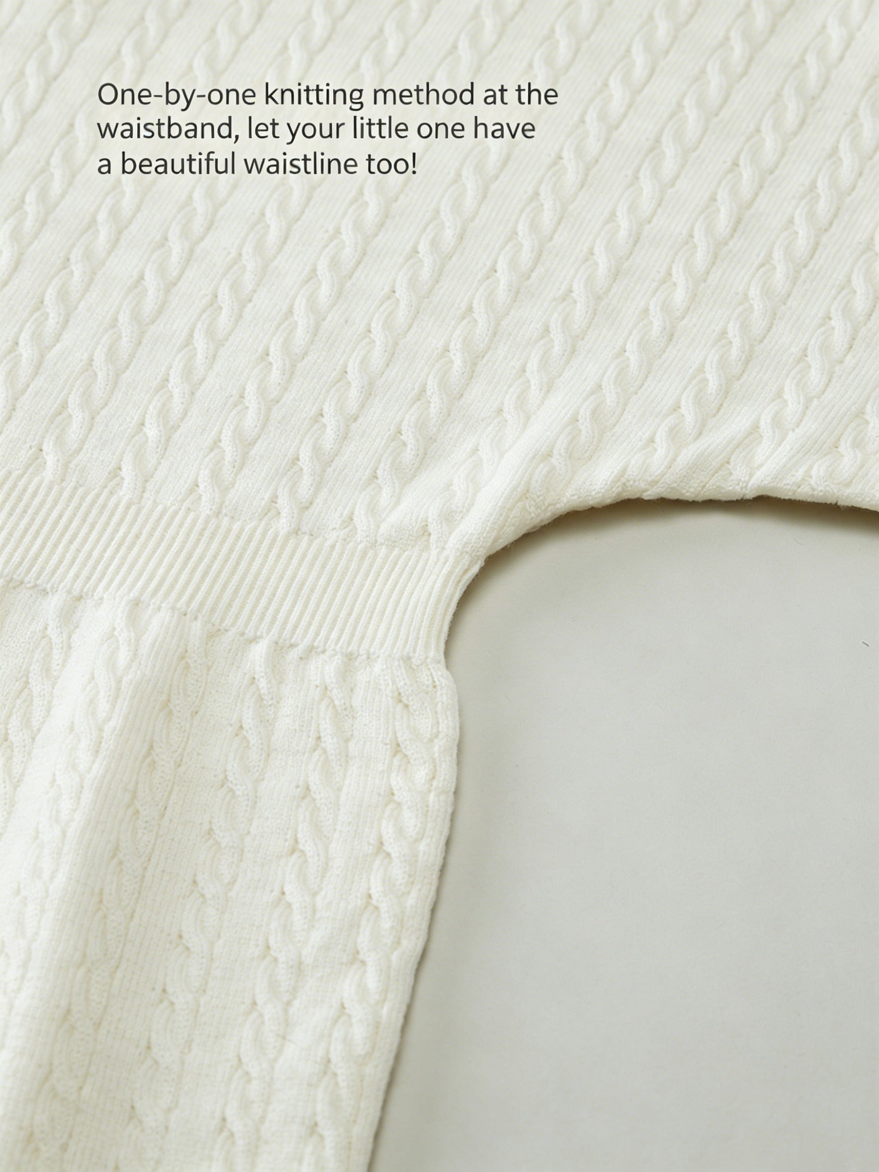 Baby wearing a soft, white ArborTree 100% Merino Superfine Wool dress, featuring a cozy, natural fiber design for infants.