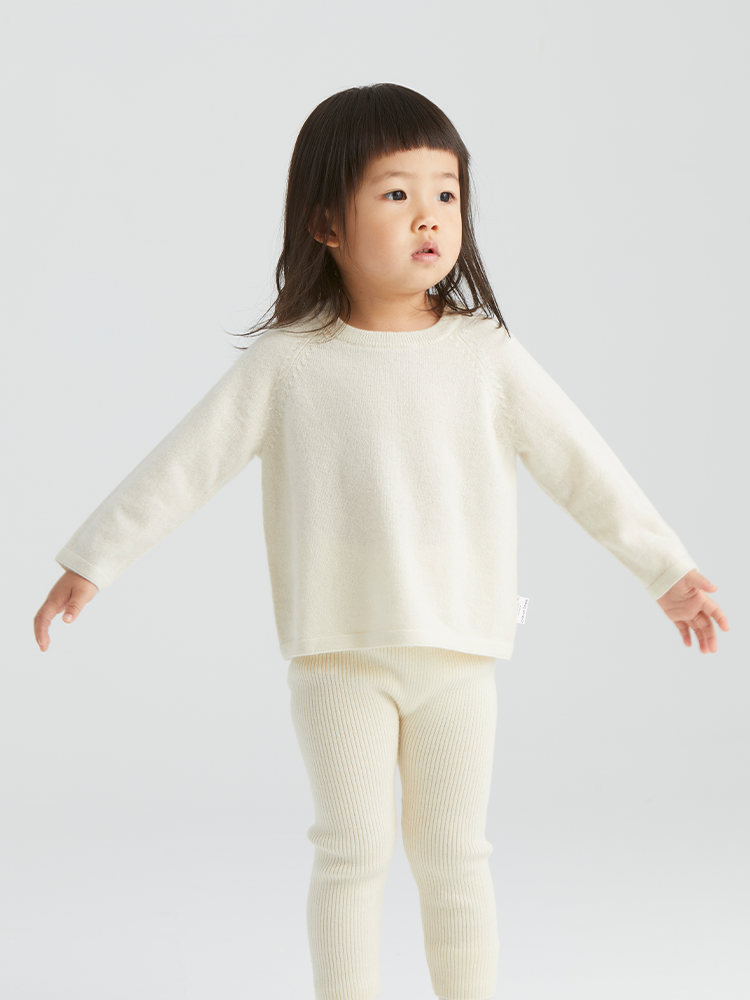 ArborTree 100% baby cashmere raglan top for kids, soft cream-colored knit with long sleeves and ribbed cuffs.