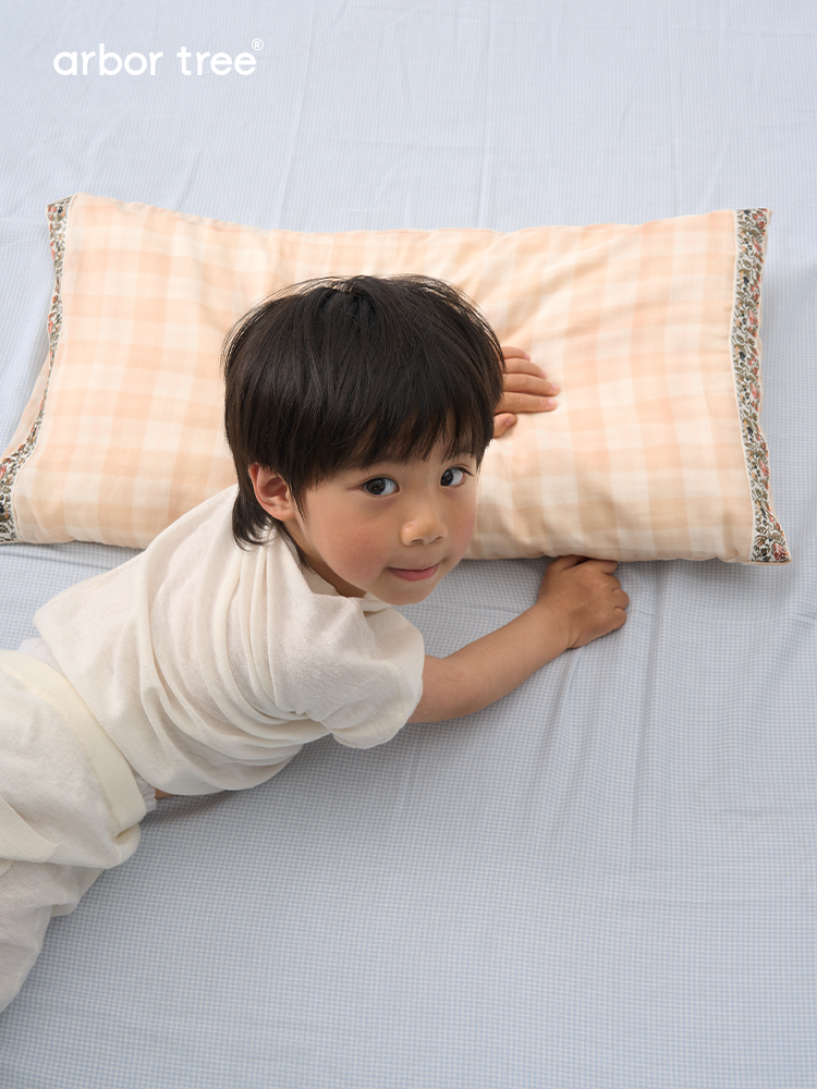 ArborTree organic cotton and tussah silk baby pillow showing breathable, moisture-wicking fabric in natural undyed tones.