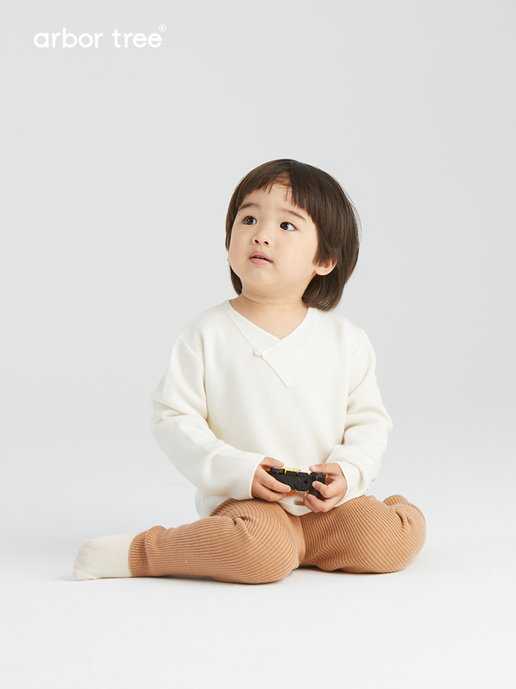 ArborTree baby pullover sweater made of 100% Baselwool with button-down front, in soft, natural wool for cozy comfort.