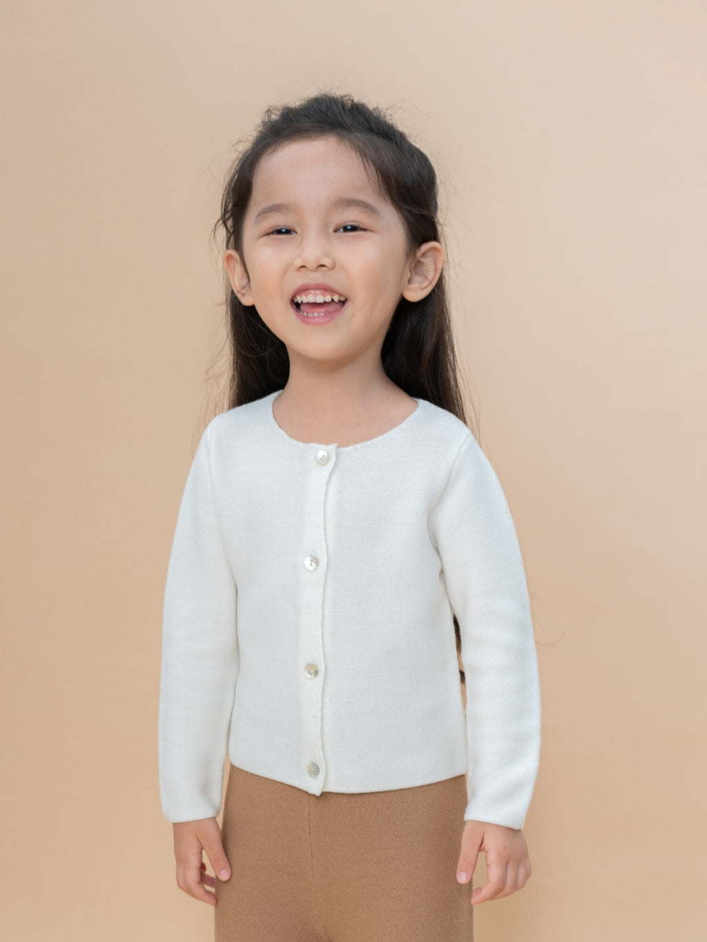 Baby wearing ArborTree 100% Merino Wool cardigan coat, soft and warm, natural source kids clothing, cozy winter outfit.
