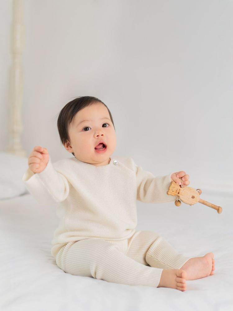 ArborTree baby and toddler drop-shoulder cashmere sweater in soft beige, perfect for boys and girls in spring, fall, and winter.