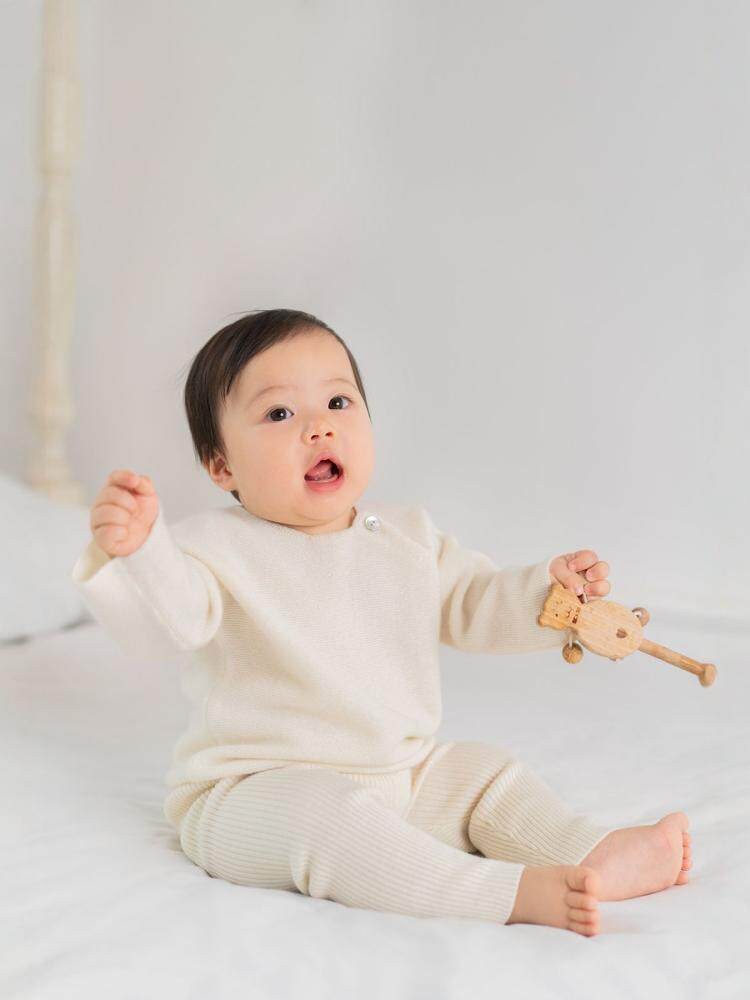 Baby cashmere raglan top by ArborTree, soft and cozy 100% cashmere sweater for kids, shown in a natural color.
