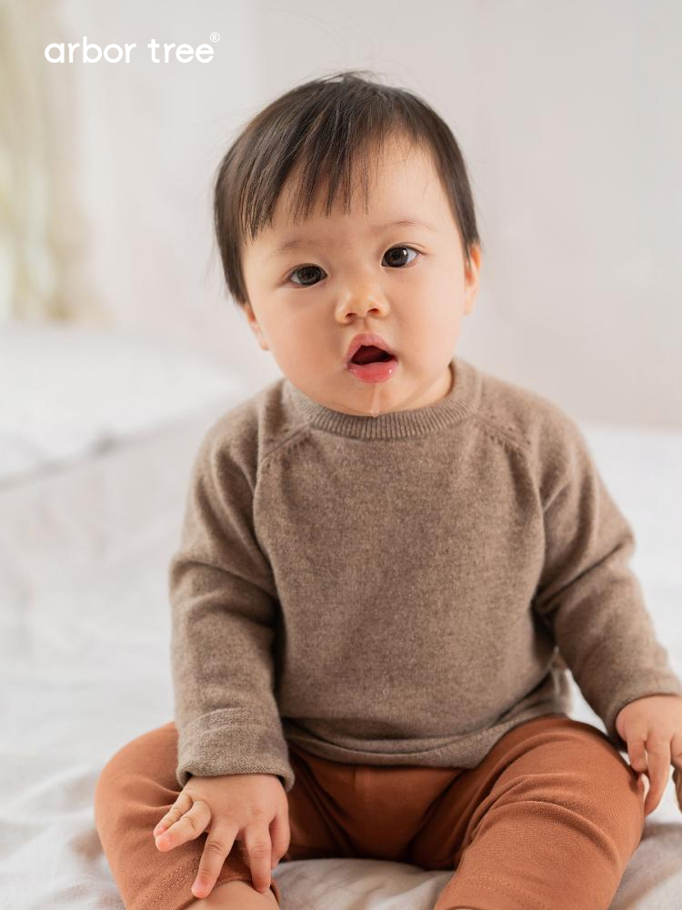ArborTree baby cashmere raglan top in soft cream, featuring long sleeves and a cozy, natural knit for infants.